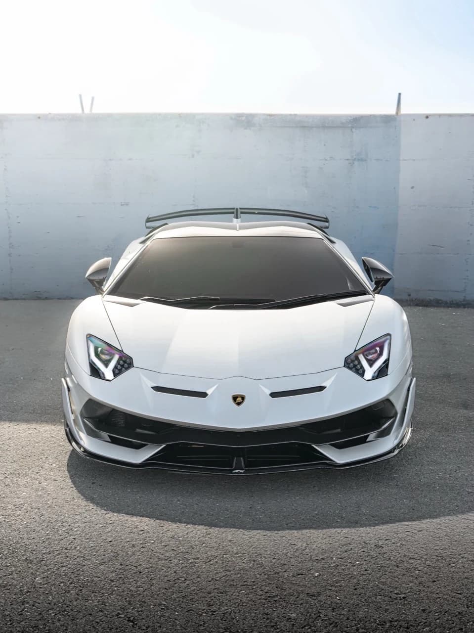 Portrait composition of a white Lamborghini viewed from the front